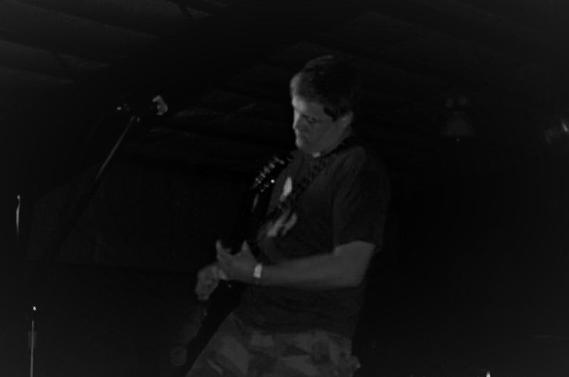 black and white image of a guitarist